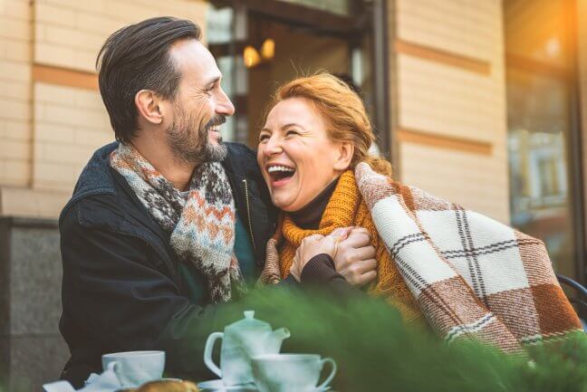 middle aged couple happy cafe funeral insurance