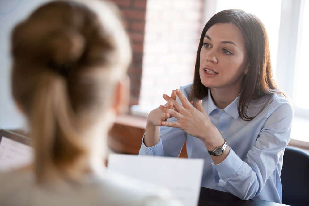 A woman negotiating rental lease with property manager