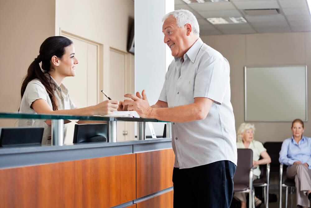 an elderly gentleman at a hospital reception area