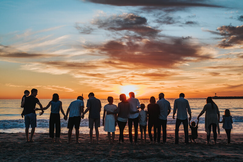 Family standing on beach