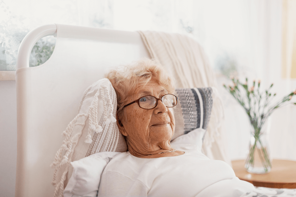 a senior woman staying in a private hospital covered by health insurance