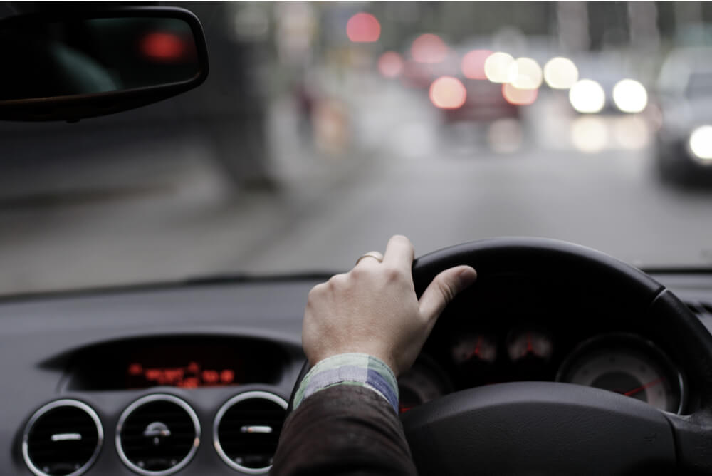 A hand on a steering wheel