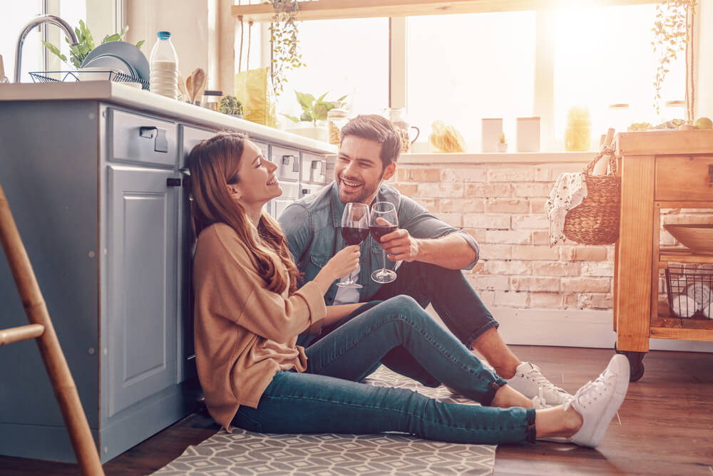 couple sitting on kitchen floor