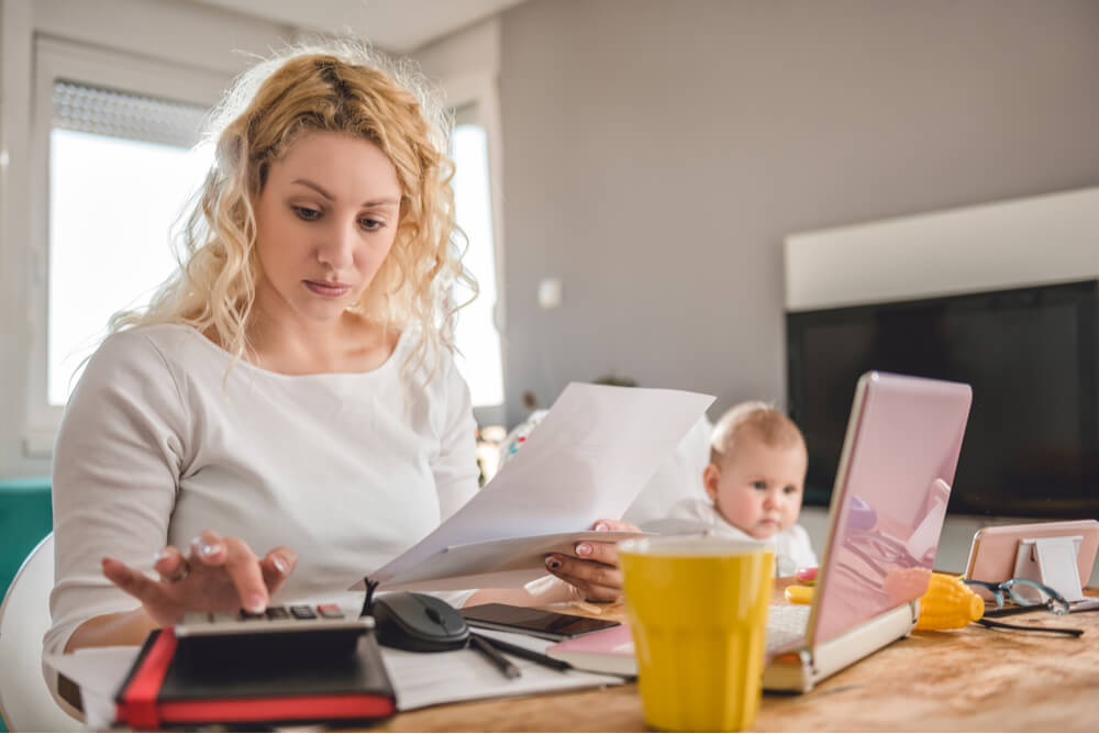 Single mother calculating bills.