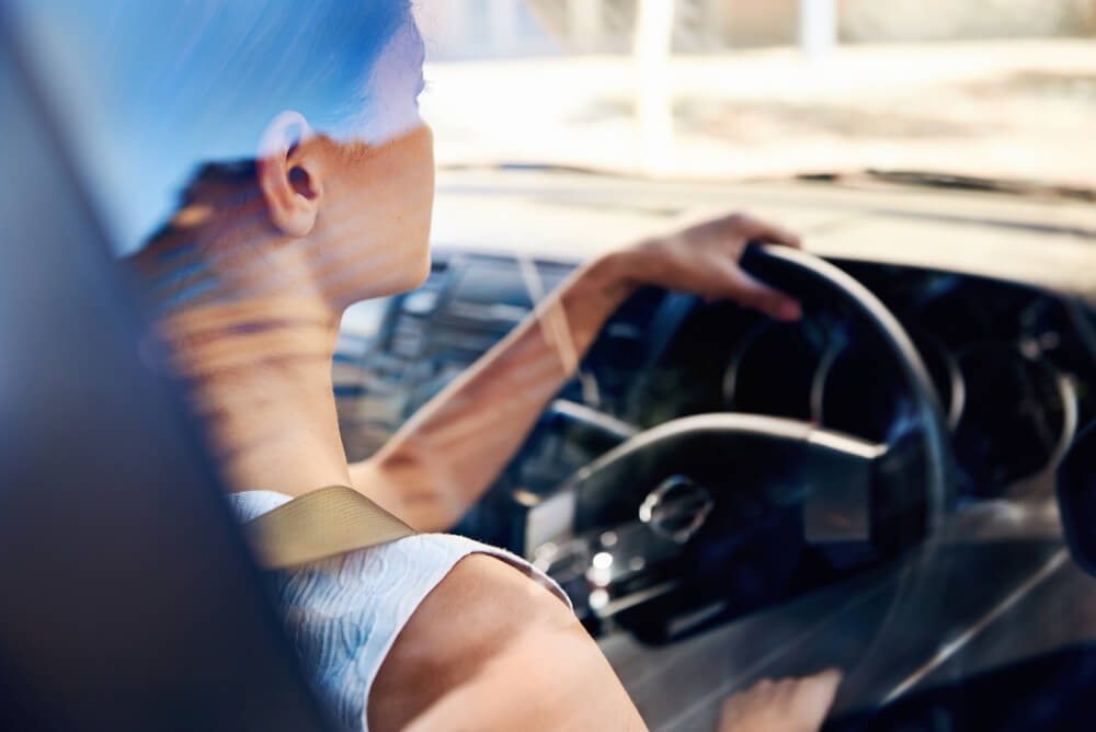 A woman driving a car.
