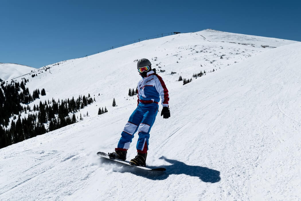 a man snowboarding down a slope