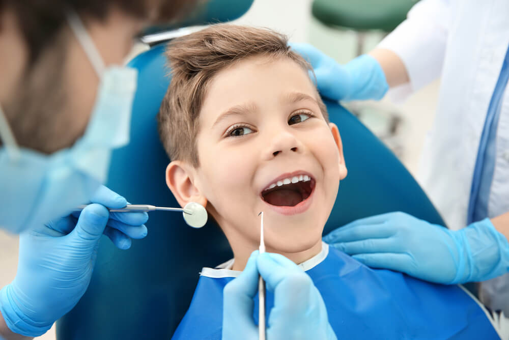 young boy receiving dental treatment through family extras cover