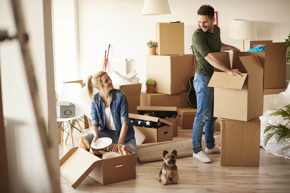 a couple moving into their new home with their pet