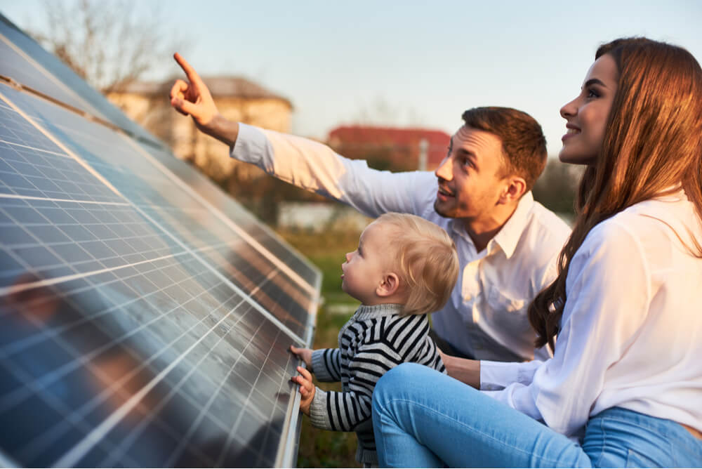 a family inspects a solar panel