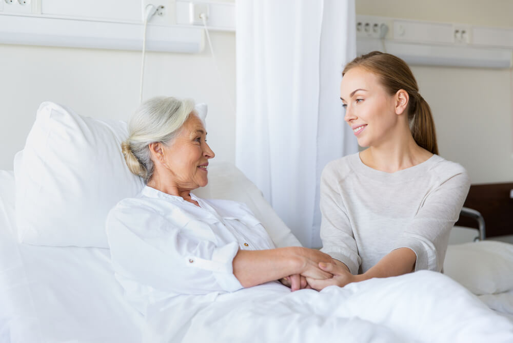 an older woman has a younger female visitor in hospital