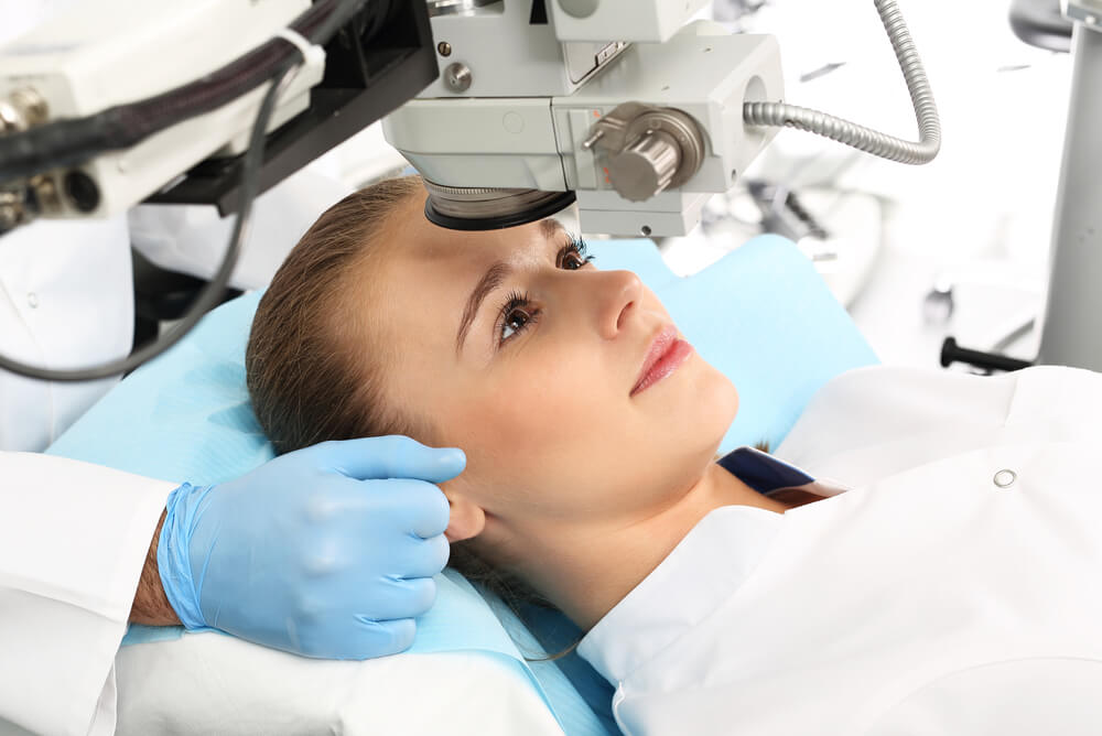 young woman getting laser eye surgery covered through optical health insurance benefits