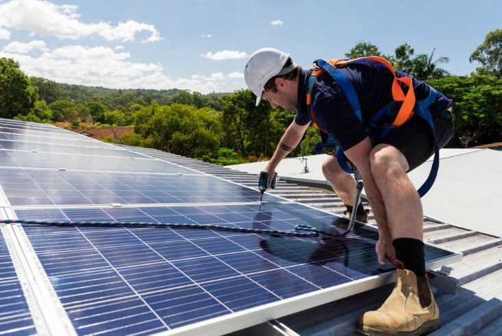 man installing solar rooftop panel