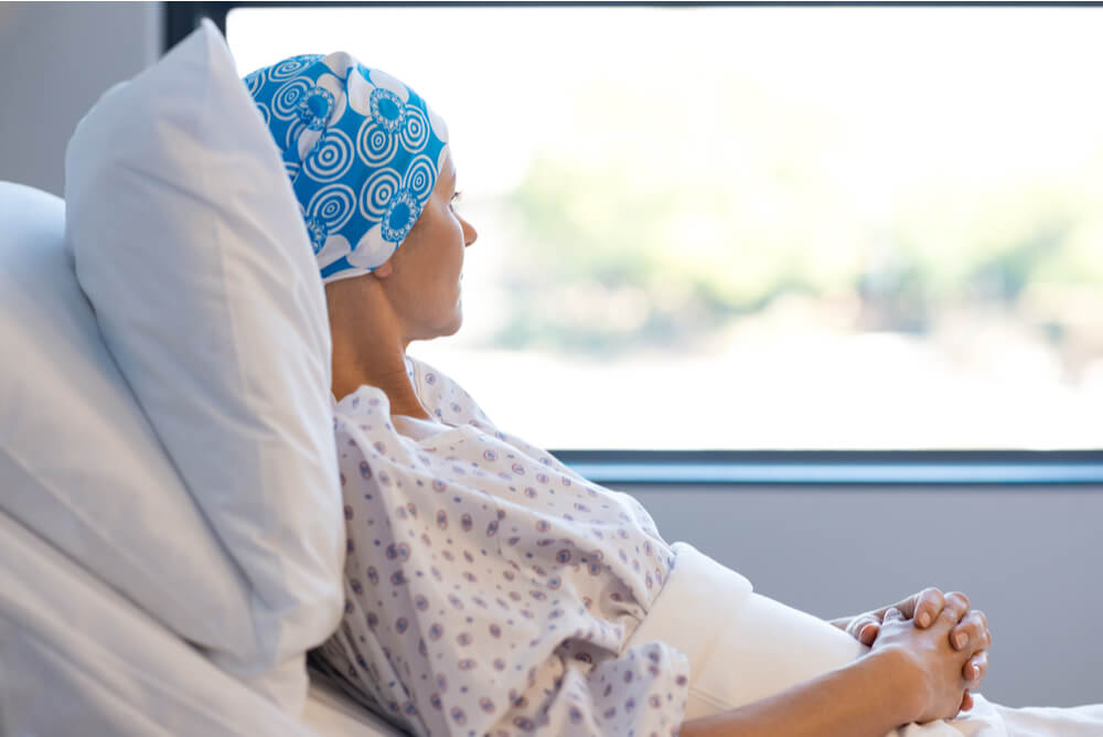 female patient in hospital bed covered by women's health insurance