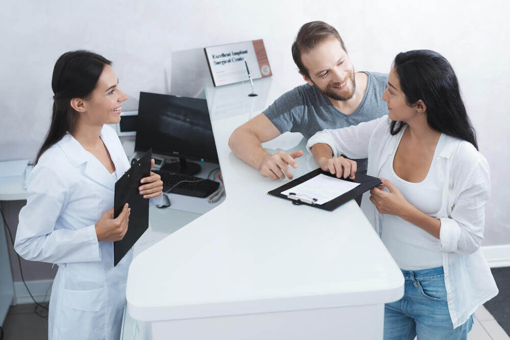 man-and-woman-visiting-dental-clinic-asking-how-much-they-can-claim-on-dental-insurance